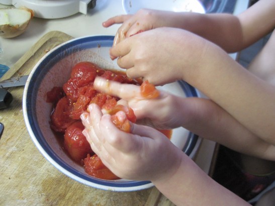 Put the kids to work squeezing the life out of the tomatoes.